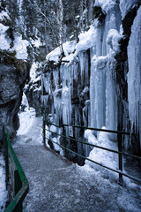 Breitachklamm Alps - snow and dramatic frozen ice covered paths within a gorge and mountains 