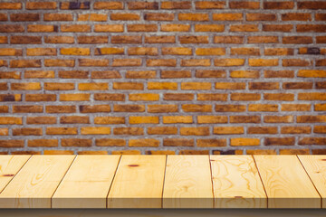 Wood table top on old vintage brick wall background product display