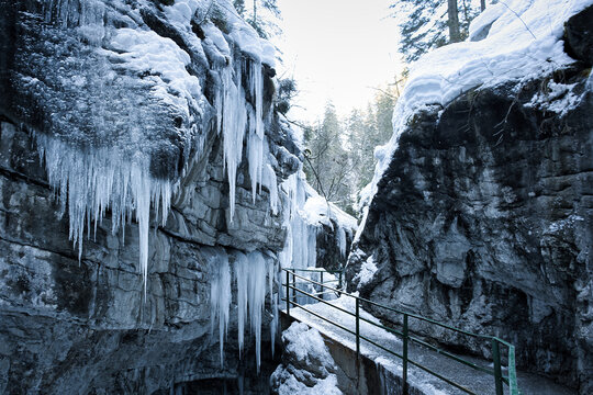 Breitachklamm Alps - snow and dramatic frozen ice covered paths within a gorge and mountains 