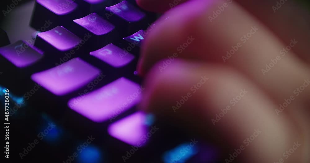 Aufkleber close up hands shot showing a gamer pushing the keyboard buttons while playing an online shooter vid