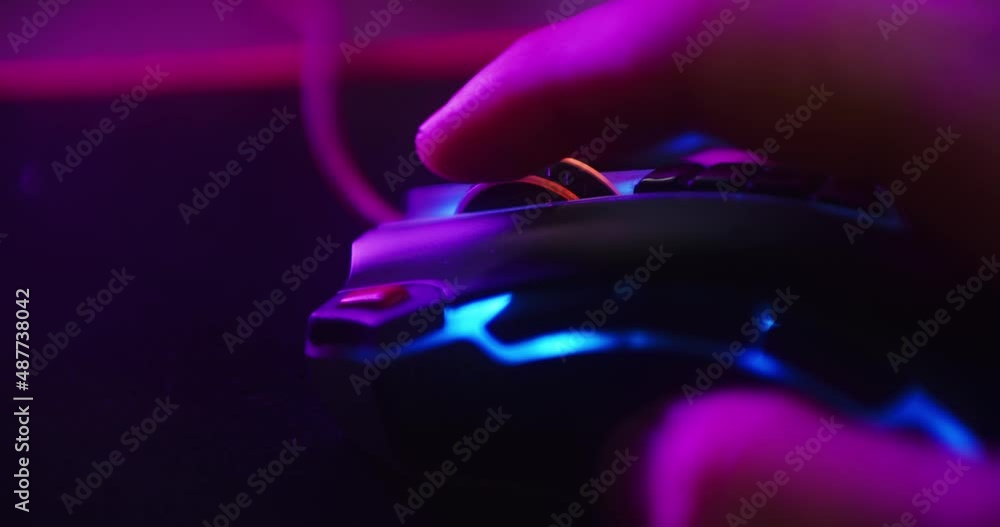 Poster close up shot of a hand scrolling the mouse wheel while playing games and clicking on a computer