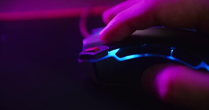 Close up shot of a hand clicking the mouse button while playing games and clicking on a computer