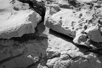 Limestone rocks by the Adriatic sea coast, unusual shapes and formations, black and white