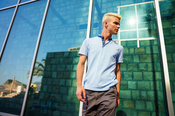 Portrait of young happy man in urban background