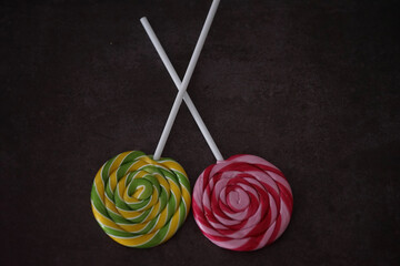 Colorful lollipops on dark background