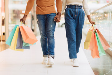 Closeup of black couple walking with shopping bags