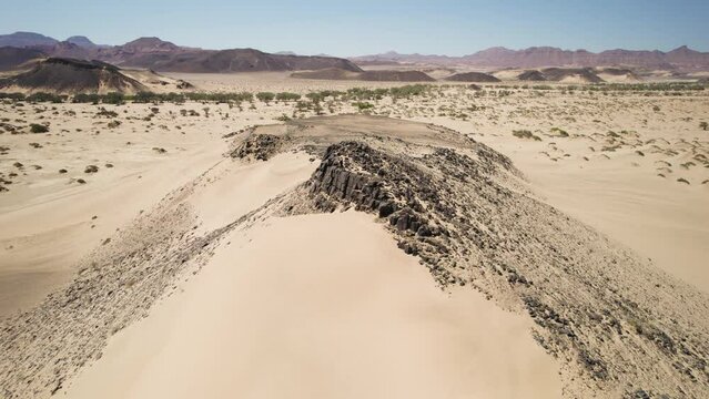 Travelers exploring the dunes and desert landscape of Namibia, Africa; aerial