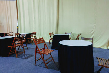 Empty round cafe tables with wooden chairs