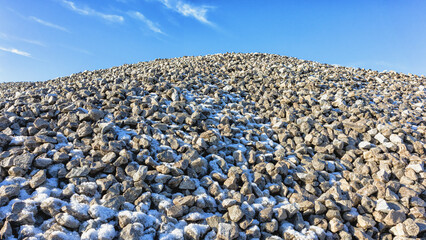 A pile of rubble with snow in winter