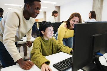 Young students using computers inside technology class at college school - Focus on center girl face