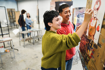 Multiracial students painting inside art room class at school - Focus on girl face