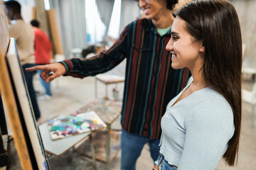 Young students painting inside art room class at university - College school and art concept - Focus on girl eye