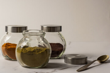 A set of spices for Asian dishes. Ground spices in clear glass jars