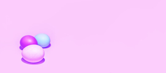 Banner with painted Easter eggs on a background of color very peri . With space to copy. High quality photo