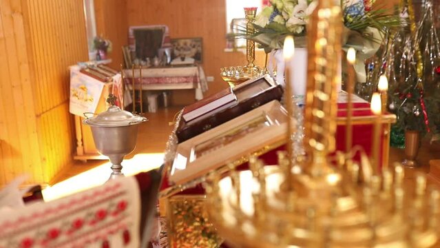 View at the Many ortodox Church Candles Burning in the Temple. The Holy bible, font for the sacrament , Orthodox item, Orthodox cross in church, Christianity concept