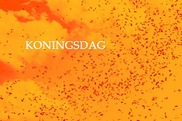 Koningsdag in the Netherlands. Dutch national holiday celebrating King's birthday. .Orange sky with festive confetti