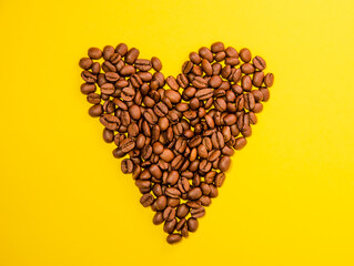 heart made of coffee beans on a yellow background