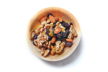 Mix fruit and nut mix in a small wooden cup on a white background. Healthy choice for energy. Raisins, walnut, almond in a bowl. Nature product