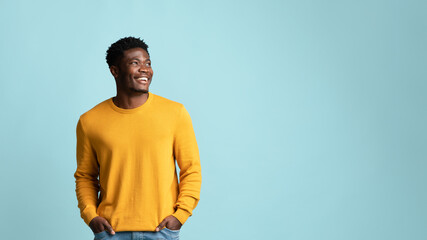 Happy black man in casual looking at copy space