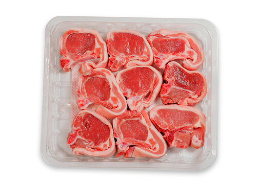 Nine Fresh Lamb Chops On A Plastic Tray. Meat Industry Product. Butcher Craft. Fresh Meat On A Bone Uncooked. White Background. Top Down View