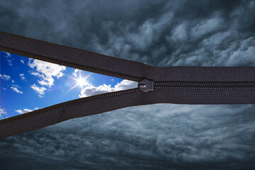 Concept black thunder clouds with zipper and sunny summer blue sky with clouds on the background.Change weather. © freeman83