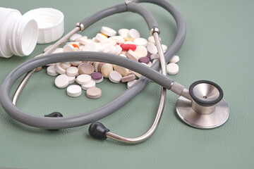 Stethoscope and bunch spilled expired pills.