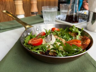 schnitzel with vegetables in a pan