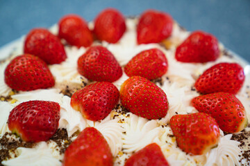 part of. cake decorated with whipped cream and fresh strawberries. 