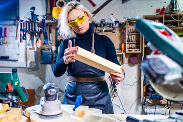 Busy wood designer in a small carpentry workshop
