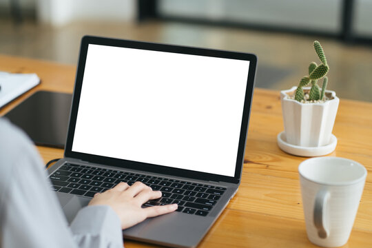 Close up image of a female assistant working on laptop computer at her workspace. laptop blank screen mockup.