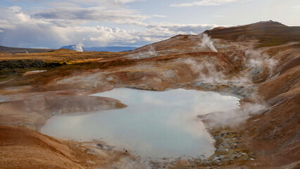 a soaring hot spring in the form of a small lake in Iceland