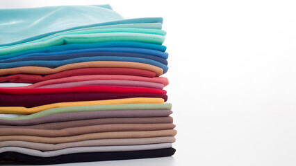 Rolls of bright colored fabric on a white background.
