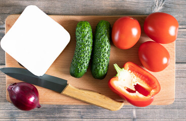 Vegetables and brynza for traditional Bulgarian shopska salad on wooden board