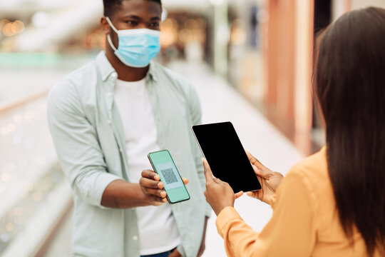 Worker Scanning Visitor's Qr Code On Entrance To Public Place