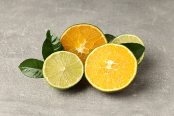 Concept of tasty food with citrus fruits on gray textured background