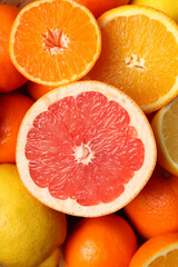 Various whole and half citrus fruits, close up