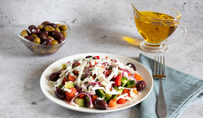 Bulgarian shopska salad with vegetables and brynza on light concrete background