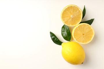 Lemons with leaves on white background, top view