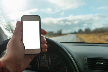 Man using blank white screen mobile smartphone inside a car in spring day landscape. copy space for your advertisement,mockup.