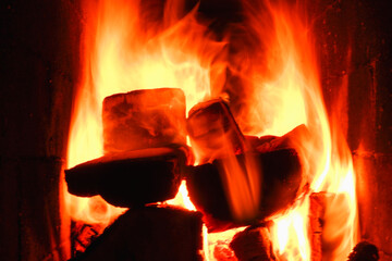 Burning firewood and coals in a stone stove. Brick oven on wood. Long tongues of flame of burning...