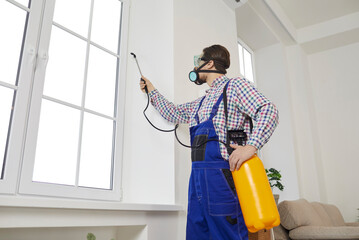 Male worker with chemicals disinfect client home from insecticide. Man specialist from pest control...