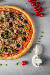 Pizza with mushrooms and cheese on a light gray background