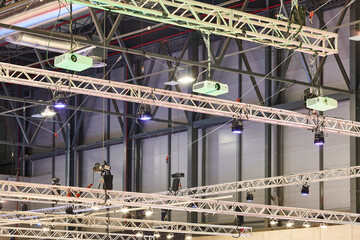 Lighting and projectors truss structure indoor set. Exhibition hall. Convention