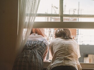 Girls Looking Out The Window