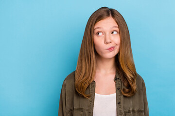 Photo of young hesitant small lady look blank space brainstorming displeased dislike isolated on...