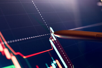 Financial chart with pen, stock analysis data for business background on digital screen. Graphs of...