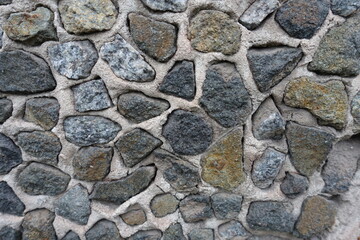 Close shot of wall with dark gray gravel pebble dash