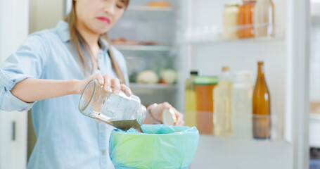 woman is pouring food waste
