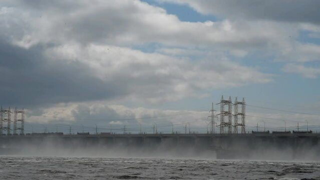 view of the bridge of the M5 road and the discharge of water at the hydroelectric power station across the Volga River near Zhigulevsk in gloomy weather.
