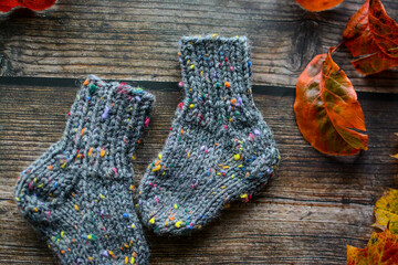 Fototapeta na wymiar Chunky gray newborn socks, made of soft cotton yarn